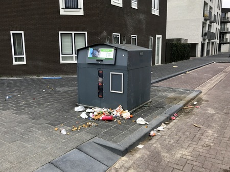 Almere, the Netherlands - March 8, 2019: Litter around a Dutch garbage recycle container.のeditorial素材
