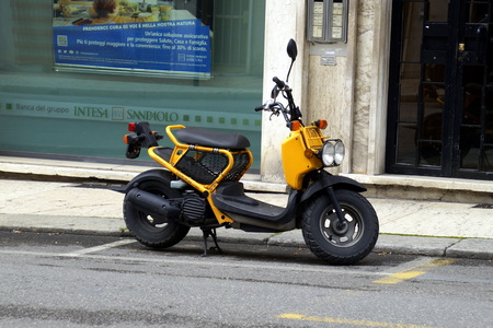 Verona, Italy - April 29, 2019: Yellow Honda Zoomer parked by the side of the road.のeditorial素材