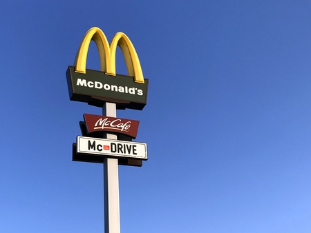 Merklingen, Baden-W?rttemberg, Germany - April 19, 2019: McDonald's, McCafe and McDrive signpost against a blue sky.のeditorial素材