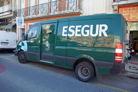 Albufeira, Portugal - December 27, 2019: Green Esegur armored truck parked by the side of the road.