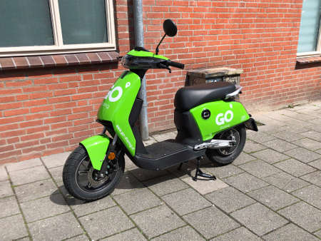Groningen, the Netherland - July 26, 2020: Green electric Go Sharing scooter parked by the side of the road.のeditorial素材