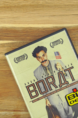 Amsterdam, the Netherlands - November 1, 2020: DVD movie cover Borat against a wooden background.のeditorial素材