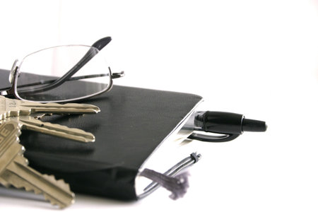 Everyday essentials; keys, eyeglasses, pen, notebookの写真素材