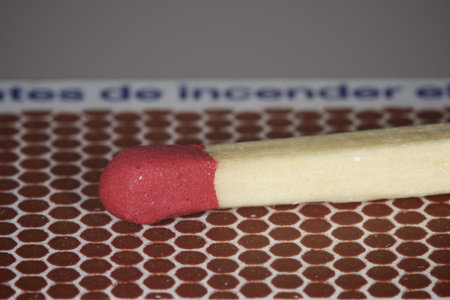 Matchstick lying on matchbox