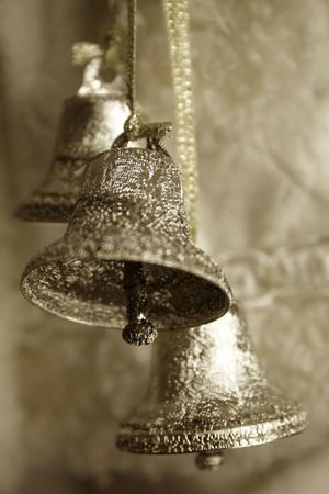 Sepia toned image of three silver bellsの写真素材