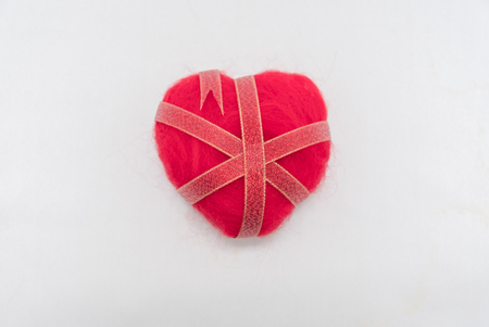Ribbon wrapped heart on wood backgroundの写真素材
