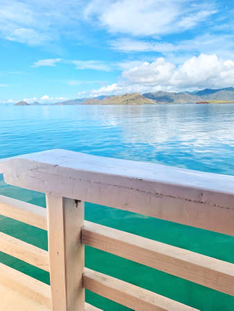 View the sea and land with a cloudy blue sky from a sailing shipの写真素材