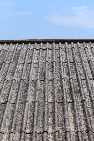 Old roof house against blue skyの写真素材