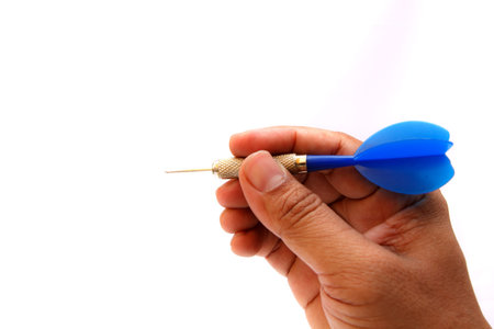 Blue arrow darts in hand isolated on white backgroundの写真素材