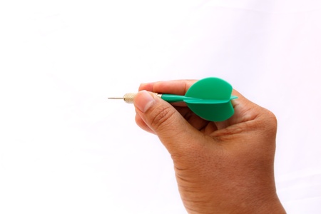 Green arrow darts in hand isolated on white backgroundの写真素材
