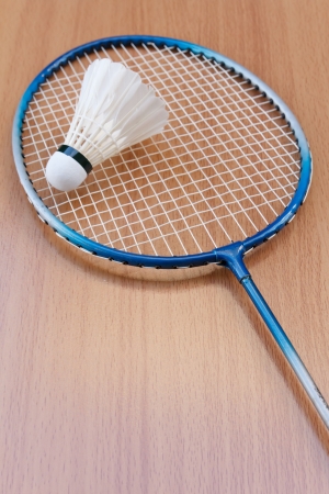 Badminton racket and shuttlecock on wooden backgroundの写真素材