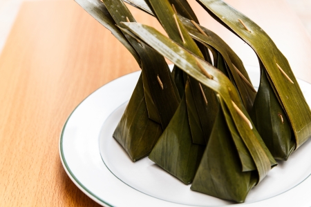 Sugarpalm cake wrapped in banana leavesの写真素材