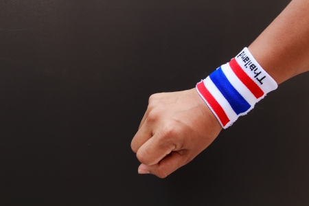 Man hand with wristband which Thailand flag colorsの写真素材