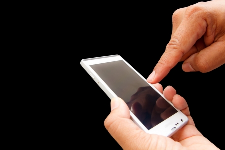 Hand used Touch screen mobile phone in black の写真素材