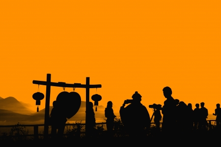 Silhouette of people take photo with sky backgroundの写真素材