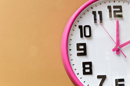 Close up of a clock isolated on yellow background with copy space-2