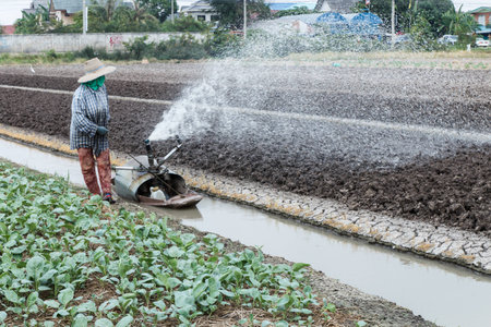 Rural farmer working on the field on daytime-2の写真素材
