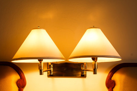 Lamps on the wall above the bedの写真素材