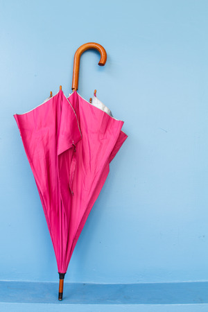 Pink umbrella on blue backgroundの写真素材