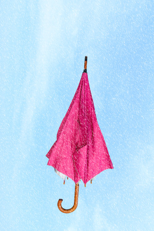 Pink umbrella on blue  sky backgroundの写真素材