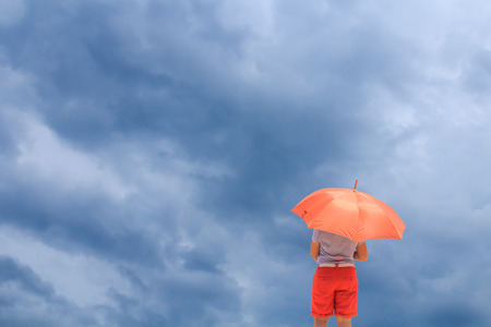 Woman with umbrella and sky backgroundの写真素材