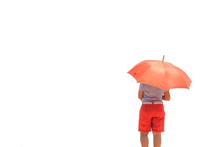 Woman with umbrella relaxation on the beachの写真素材