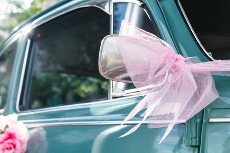 Vintage wedding car with pink mirrorの写真素材