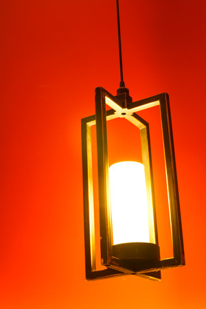 Lamp on the wall above the bedの写真素材