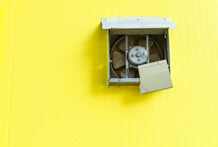 fan of air conditioner on yellow backgroundの写真素材
