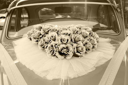 Flower arrangement tied to a wedding carの写真素材