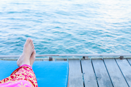 Closeup of woman feet relaxing on beachの写真素材