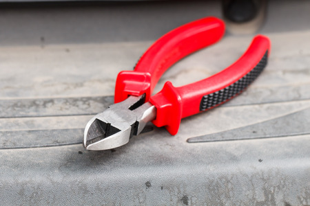 Red pliers on the black backgroundの写真素材