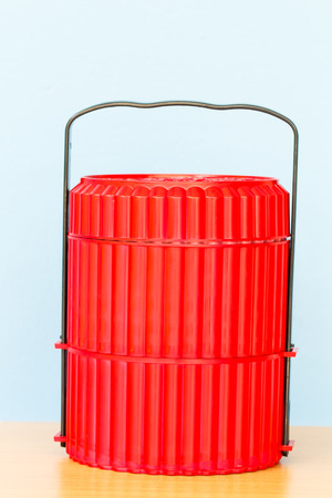Red food carrier with blue backgroundの写真素材