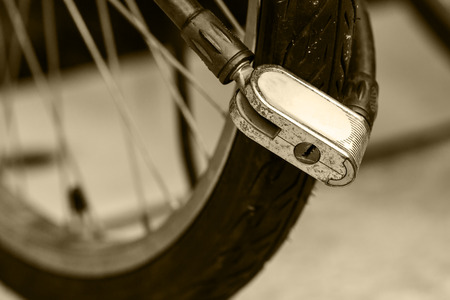 Security lock blocking the bicycle wheel in parkの写真素材