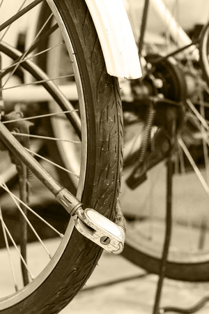 Security lock blocking the bicycle wheel in parkの写真素材