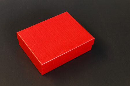 Red paper box isolated on black backgroundの写真素材