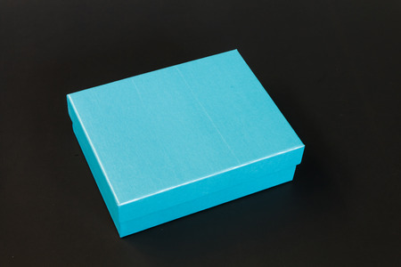 Light blue paper box isolated on black backgroundの写真素材
