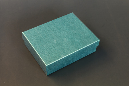 Green paper box isolated on black backgroundの写真素材