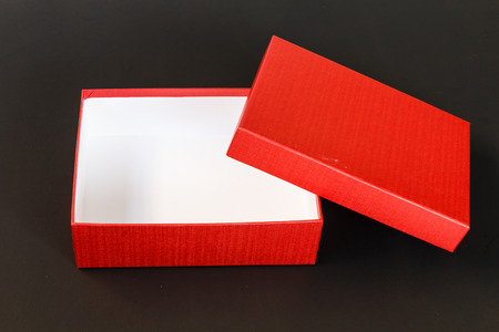 Red paper box isolated on black backgroundの写真素材