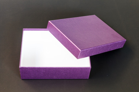 Purple paper box isolated on black backgroundの写真素材