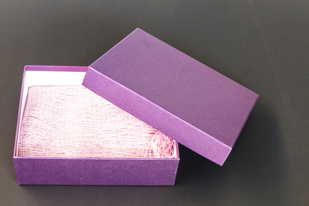 Purple paper box isolated on black backgroundの写真素材