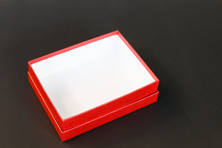 Red paper box isolated on black backgroundの写真素材
