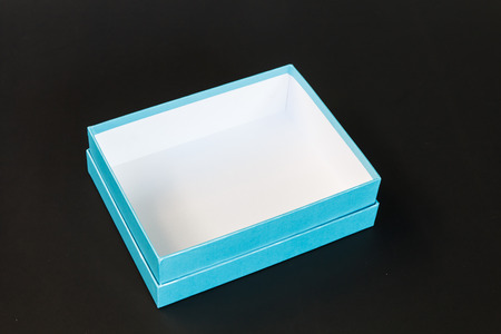 Light blue paper box isolated on black backgroundの写真素材