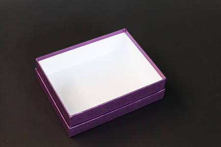 Purple paper box isolated on black backgroundの写真素材