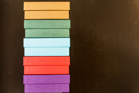 Colors paper box isolated on black backgroundの写真素材