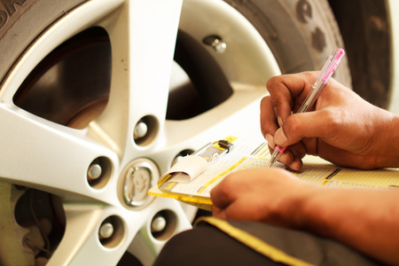 Close-up of man hand in maintaining car recordsの写真素材