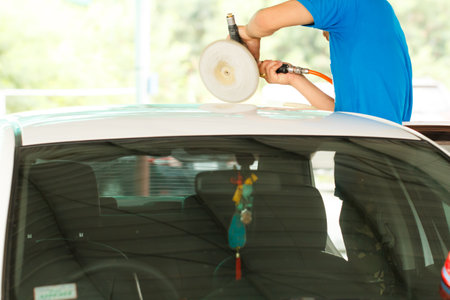 Hands with orbital polisher in auto car repair shopのeditorial素材