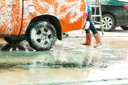 Worker washing car in the carwash-selective focusのeditorial素材