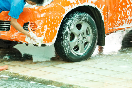 Worker washing car in the carwash-selective focusのeditorial素材