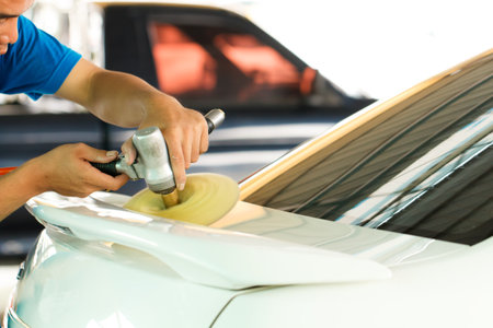 Hands with orbital polisher in auto car repair shopのeditorial素材